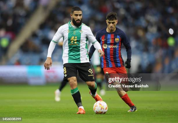 Nabil Fekir of Real Betis battles for possession with Pedri of FC Barcelona during the Super Copa de España match between Real Betis and FC Barcelona...