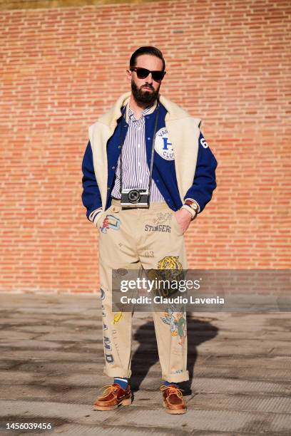 Andres Prince, wearing white Yale sweater, blue bomber jacket, white and blue stripped shirt and beige pants with sticker, is seen at Fortezza Da...