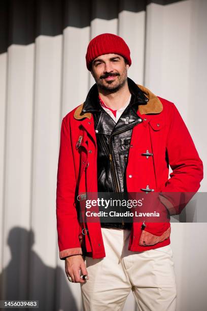 Max Poglia, wearing white pants, black leather jacket, red Fay jacket and red cap, is seen at Fortezza Da Basso on January 12, 2023 in Florence,...