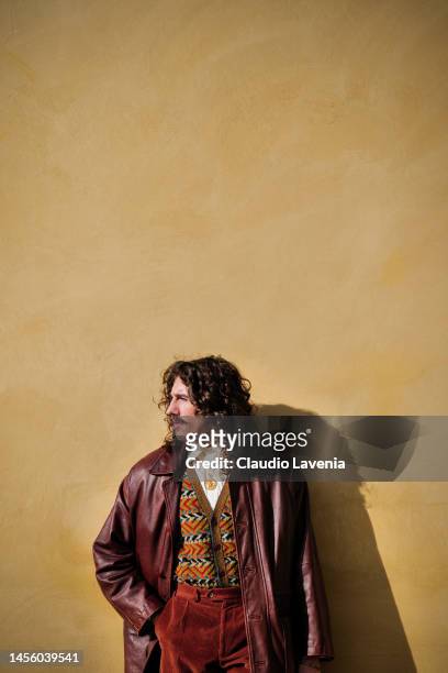 Guest, wearing a red velvet pants, red leather trench, multicolor gilet and white shirt, is seen at Fortezza Da Basso on January 12, 2023 in...