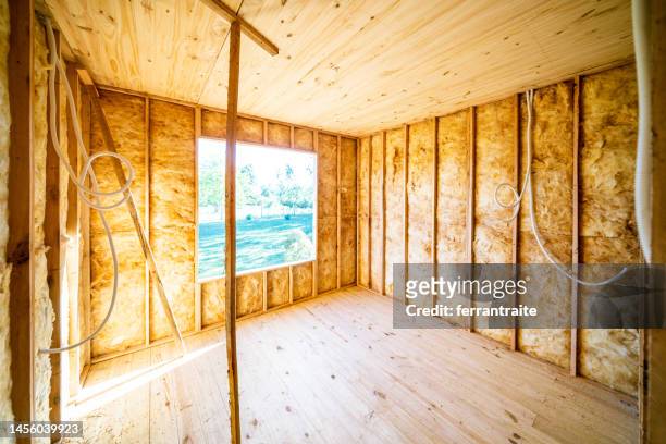wooden house construction site interior - isolatiemateriaal stockfoto's en -beelden