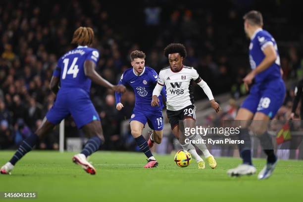 Willian of Fulham battles for possession with Mason Mount of Chelsea during the Premier League match between Fulham FC and Chelsea FC at Craven...