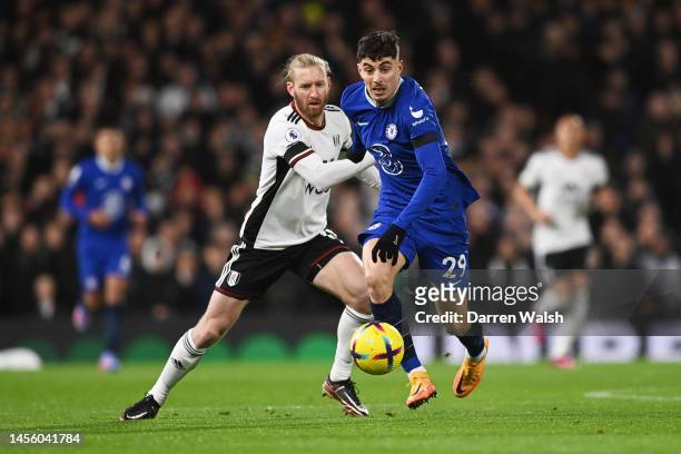 Kai Havertz of Chelsea battles for possession with Tim Ream of Fulham during the Premier League match between Fulham FC and Chelsea FC at Craven...