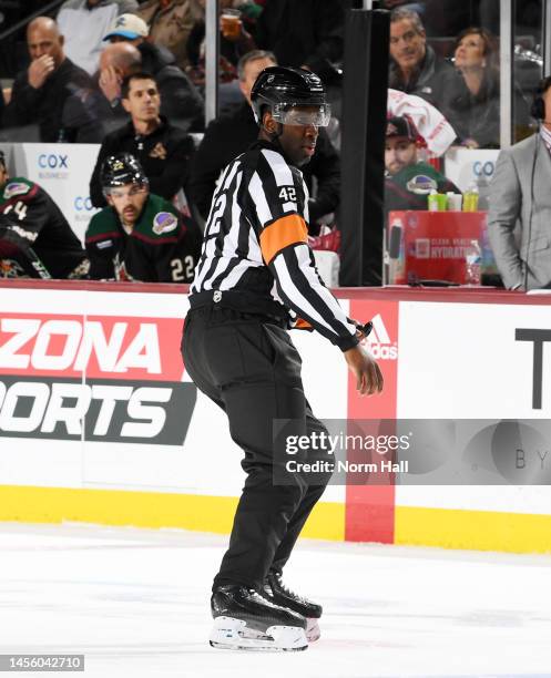 Referee Jordan Samuels-Thomas skates up ice during a game between the San Jose Sharks and the Arizona Coyotes at Mullett Arena on January 10, 2023 in...