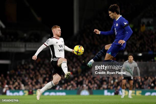 Harrison Reed of Fulham challenges Joao Felix of Chelsea in the air during the Premier League match between Fulham FC and Chelsea FC at Craven...