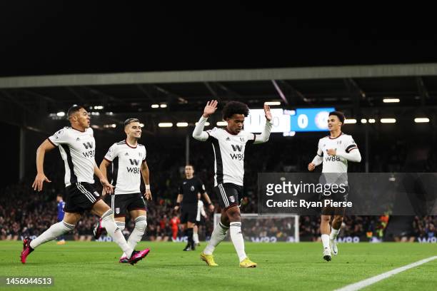 Willian of Fulham celebrates with teammates after scoring their team's first goal during the Premier League match between Fulham FC and Chelsea FC at...