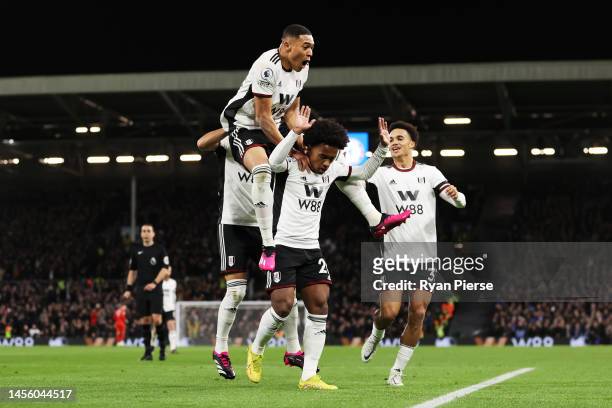 Willian of Fulham celebrates with teammates after scoring their team's first goal during the Premier League match between Fulham FC and Chelsea FC at...