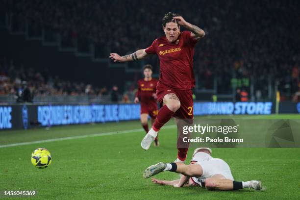 Nicolo Zaniolo of AS Roma is challenged by Lennart Czyborra of Genoa CFC during the Coppa Italia Round of 16 match between AS Roma and Genoa CFC at...