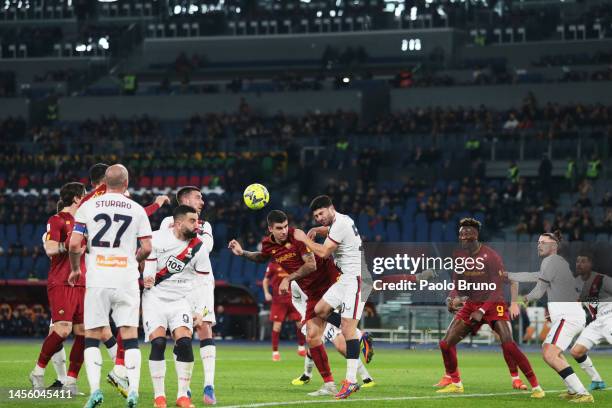 Gianluca Mancini of AS Roma heads the ball under pressure from Radu Dragusin of Genoa CFC during the Coppa Italia Round of 16 match between AS Roma...