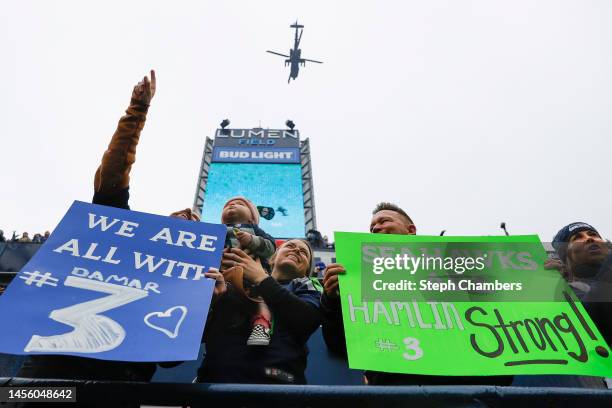 Seattle Seahawks fans hold signs in honor of Damar Hamlin of the Buffalo Bills during the game against the Los Angeles Rams at Lumen Field on January...