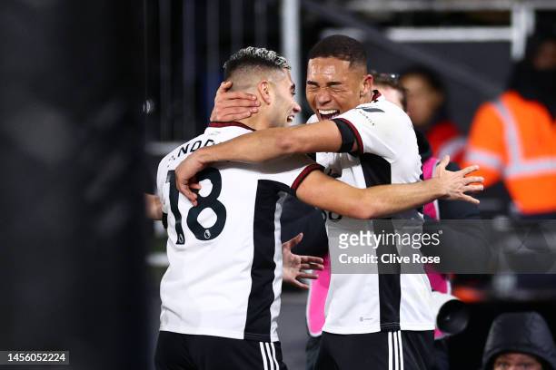 Carlos Vinicius of Fulham celebrates with teammate Andreas Pereira after scoring the team's second goal during the Premier League match between...