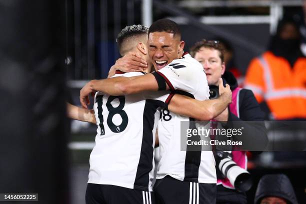 Carlos Vinicius of Fulham celebrates with teammate Andreas Pereira after scoring the team's second goal during the Premier League match between...