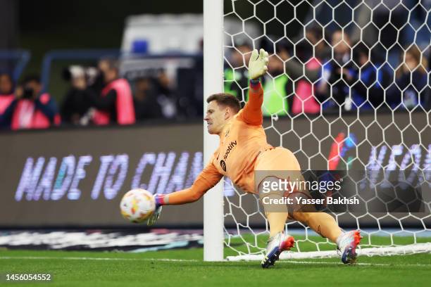 Marc-Andre ter Stegen of FC Barcelona saves the third penalty from Juanmi of Real Betis in the penalty shoot out during the Super Copa de España...
