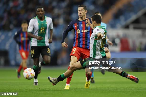 Robert Lewandowski of FC Barcelona battles for possession with Luiz Felipe of Real Betis during the Super Copa de España semi-final match between...