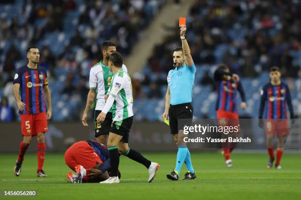 Andres Guardado of Real Betis receives a red card from match referee Carlos del Cerro Grande during the Super Copa de España semi-final match between...