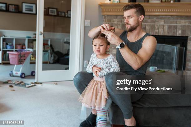 father coming toddler daughter's hair at home - house husband stock pictures, royalty-free photos & images