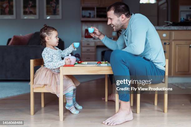 toast della bambina e del papà durante il tea party - parent foto e immagini stock