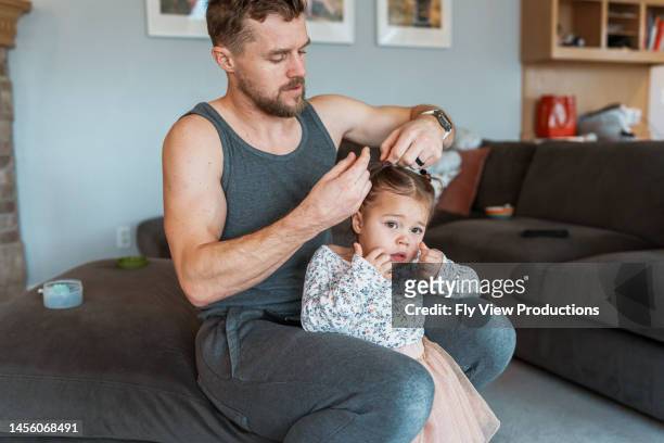 dad helping daughter get ready for preschool - comb hair care stock pictures, royalty-free photos & images