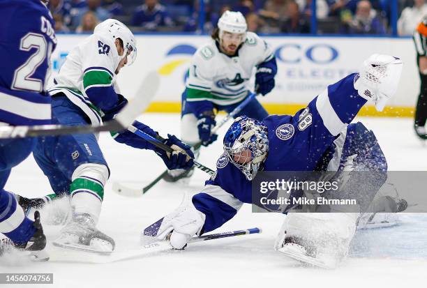 Andrei Vasilevskiy of the Tampa Bay Lightning stops a shot from Bo Horvat of the Vancouver Canucks during a game at Amalie Arena on January 12, 2023...