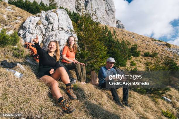 hiking friends relax on mountain ridge - escape rom stock pictures, royalty-free photos & images