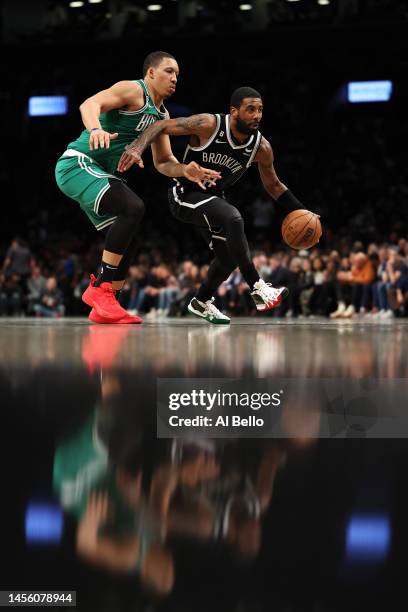 Kyrie Irving of the Brooklyn Nets drives against of the Boston Celtics during their game at Barclays Center on January 12, 2023 in New York City....