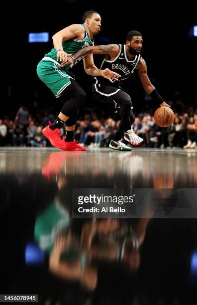 Kyrie Irving of the Brooklyn Nets drives against of the Boston Celtics during their game at Barclays Center on January 12, 2023 in New York City....