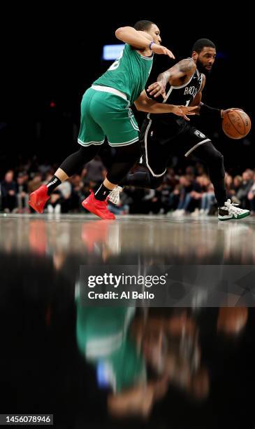 Kyrie Irving of the Brooklyn Nets drives against of the Boston Celtics during their game at Barclays Center on January 12, 2023 in New York City....