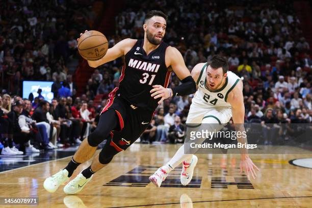 Max Strus of the Miami Heat drives past Pat Connaughton of the Milwaukee Bucks during the second quarter at the Miami-Dade County arena on January...