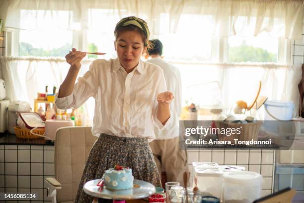 the woman tasted the cake she made and was amazed at how delicious it was. - baking competition stock pictures, royalty-free photos & images