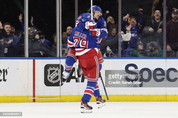 Artemi Panarin leaps to celebrate with K'Andre Miller of the New York Rangers after Miller's game-tying goal during the third period against the...