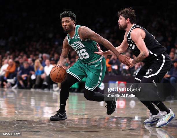 Marcus Smart of the Boston Celtics drives against Joe Harris of the Brooklyn Nets during their game at Barclays Center on January 12, 2023 in New...