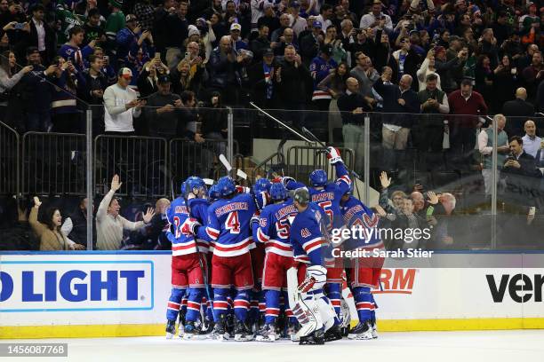 The New York Rangers celebrate after a game-winning goal by Adam Fox of the New York Rangers during overtime against the Dallas Stars at Madison...