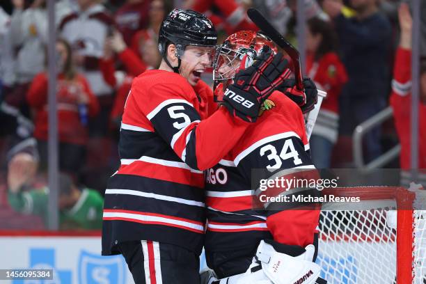 Connor Murphy of the Chicago Blackhawks celebrates with Petr Mrazek after defeating the Colorado Avalanche 3-2 at United Center on January 12, 2023...