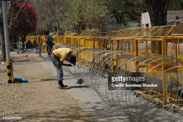 Security men erecting barbed wire fencing around the Chinese Embassy in New Delhi as additional security because of the Tibetan migrants protest...