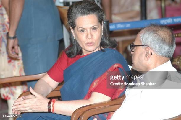 Congress President Sonia Gandhi speaking with Foreign Minister Pranab Mukherjee during a Cabinet expansion function at Presidential Palace in New...