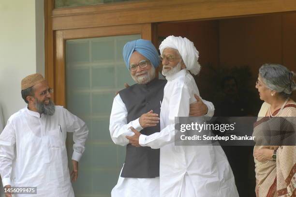 Prime Minister Manmohan Singh with his childhood friend Raja Mohammad Ali who has travelled all the way from Village Gah in Pakistan to New Delhi on...