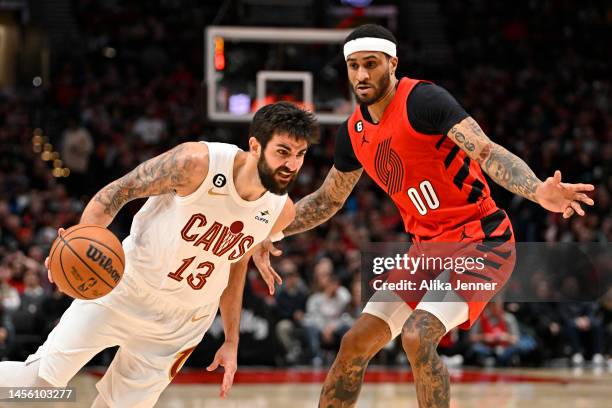 Ricky Rubio of the Cleveland Cavaliers drives against Gary Payton II of the Portland Trail Blazers during the third quarter at the Moda Center on...