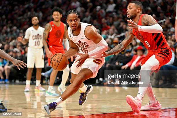 Isaac Okoro of the Cleveland Cavaliers drives against Damian Lillard of the Portland Trail Blazers during the third quarter at the Moda Center on...
