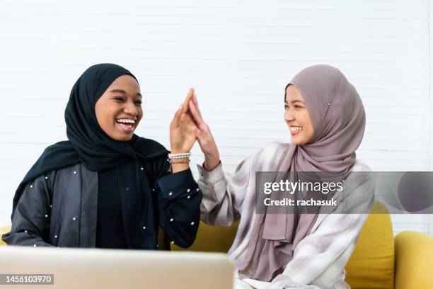 muslim woman greeting her friend and talking with smile - funny muslim stock pictures, royalty-free photos & images