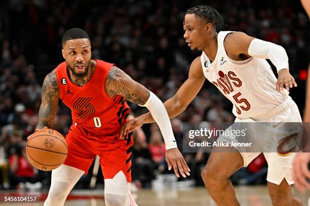 Damian Lillard of the Portland Trail Blazers controls the ball against Isaac Okoro of the Cleveland Cavaliers during the first quarter at the Moda...