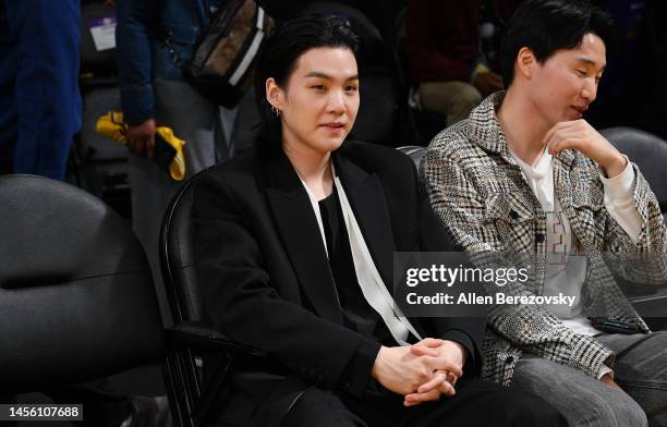 Suga of BTS attends a basketball game between the Los Angeles Lakers and the Dallas Mavericks at Crypto.com Arena on January 12, 2023 in Los Angeles,...