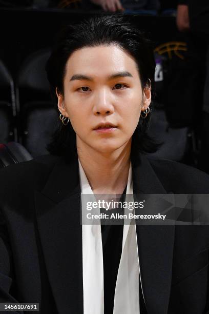 Suga of BTS attends a basketball game between the Los Angeles Lakers and the Dallas Mavericks at Crypto.com Arena on January 12, 2023 in Los Angeles,...
