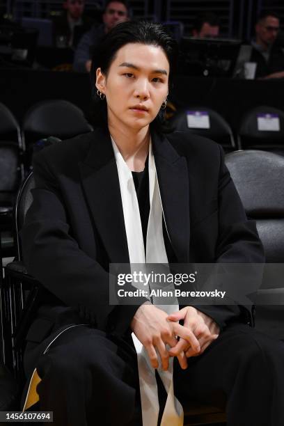 Suga of BTS attends a basketball game between the Los Angeles Lakers and the Dallas Mavericks at Crypto.com Arena on January 12, 2023 in Los Angeles,...