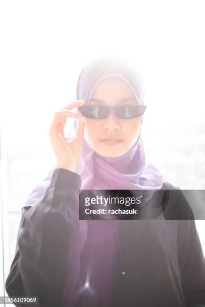 muslim teenage girl smiles at camera with lens flare - portrait lens flare stock pictures, royalty-free photos & images