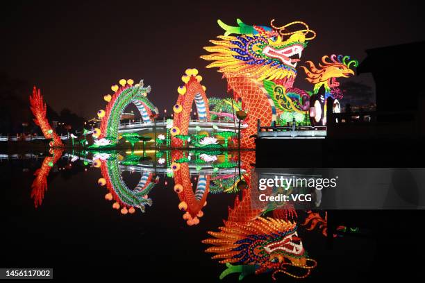 Lanterns featuring dragon and phoenix illuminate a bridge during a lantern show at Tang Paradise ahead of the Chinese New Year, the Year of the...