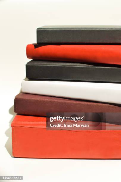 hard cover books stacked - book spine stock pictures, royalty-free photos & images