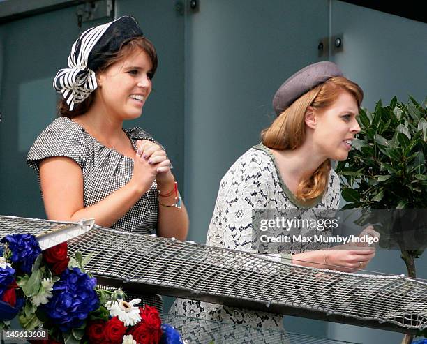 Princess Eugenie and Princess Beatrice watch the racing from the balcony of the Royal Box on Derby Day at the Investec Derby Festival horse racing...