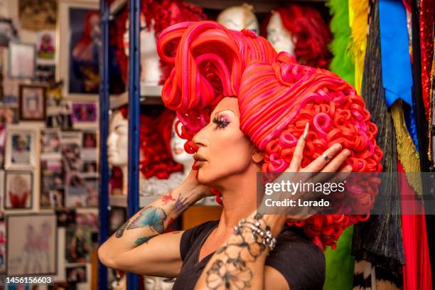 drag queen choosing a wig for a performance - cross dressing stock pictures, royalty-free photos & images