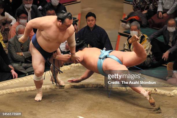 Takarafuji throws Kotoshoho to win on day six of the Grand Sumo New Year Tournament at Ryogoku Kokugikan on January 13, 2023 in Tokyo, Japan.