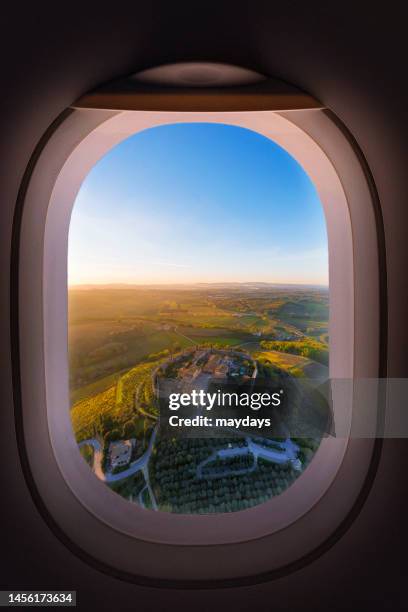 looking through an airplane window - monteriggioni stock pictures, royalty-free photos & images